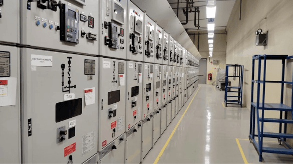 Close view of a medium-voltage switchgear lineup with section labels and device nameplates