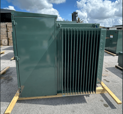 Outdoor pad-mounted distribution transformer on a wooden pallet